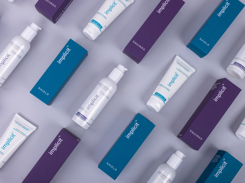 Brand implicit E.Q.U.I.N.O.X. cleanser and S.H.I.E.L.D. barrier repair gel cream arranged with their purple and teal packaging.
